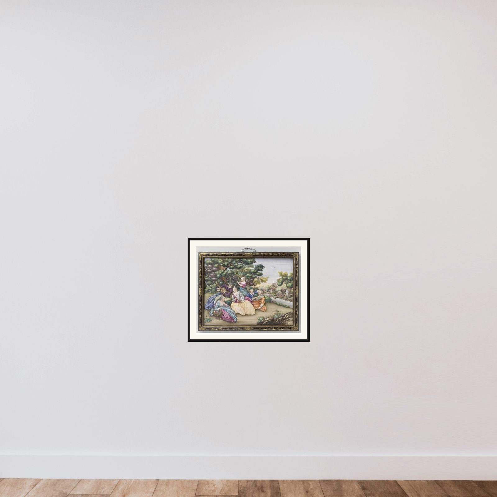 Two plaques depicting European fêtes champêtres framed — shown to scale