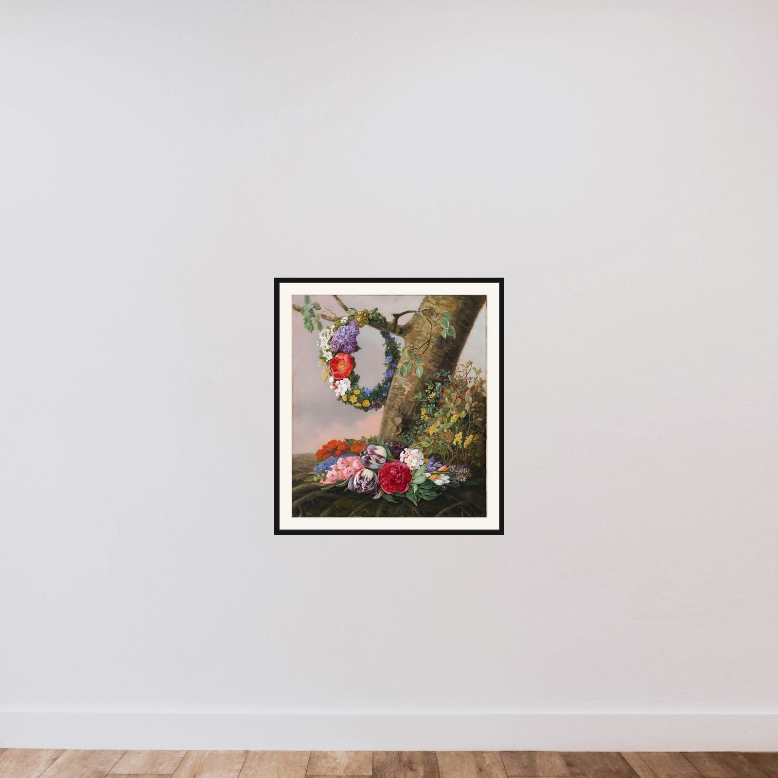En buket blomster ved foden af et træ. På en gren hænger en blomsterkrans framed — shown to scale