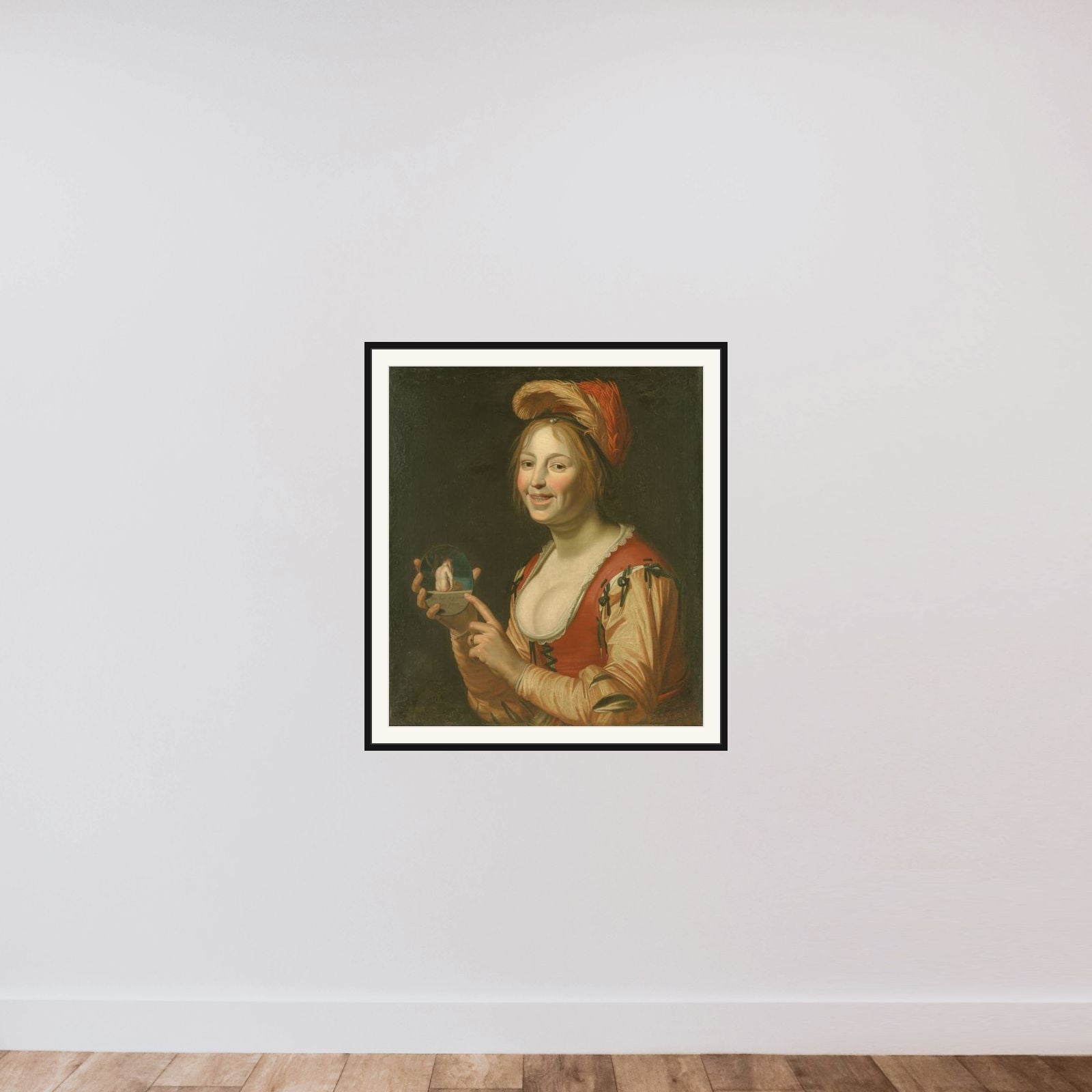 En leende pige, der fremviser et lille billede af en nøgen kvinde set bagfra framed — shown to scale