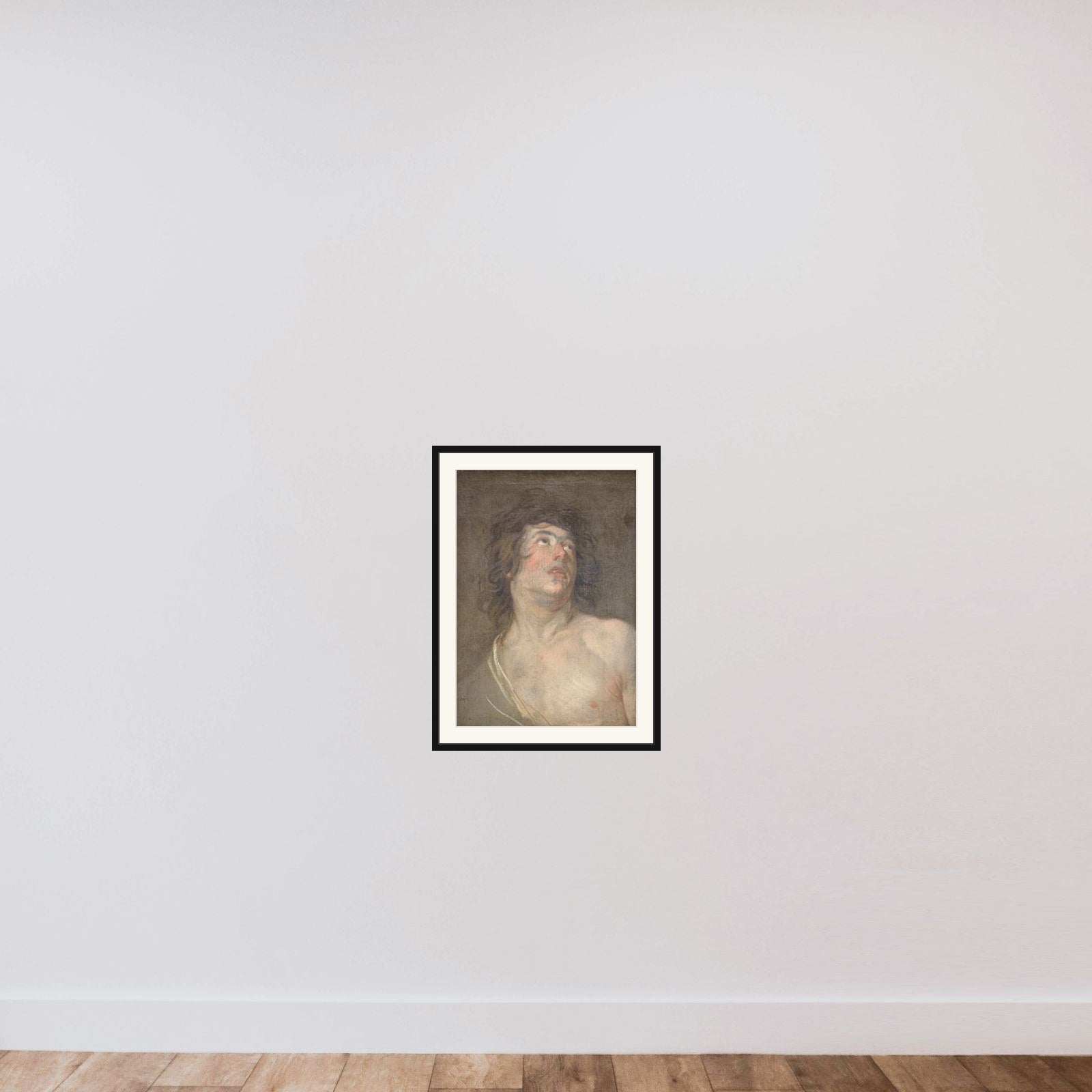 Studiehoved af en ung mand, som ser opad. Skt. Sebastian framed — shown to scale