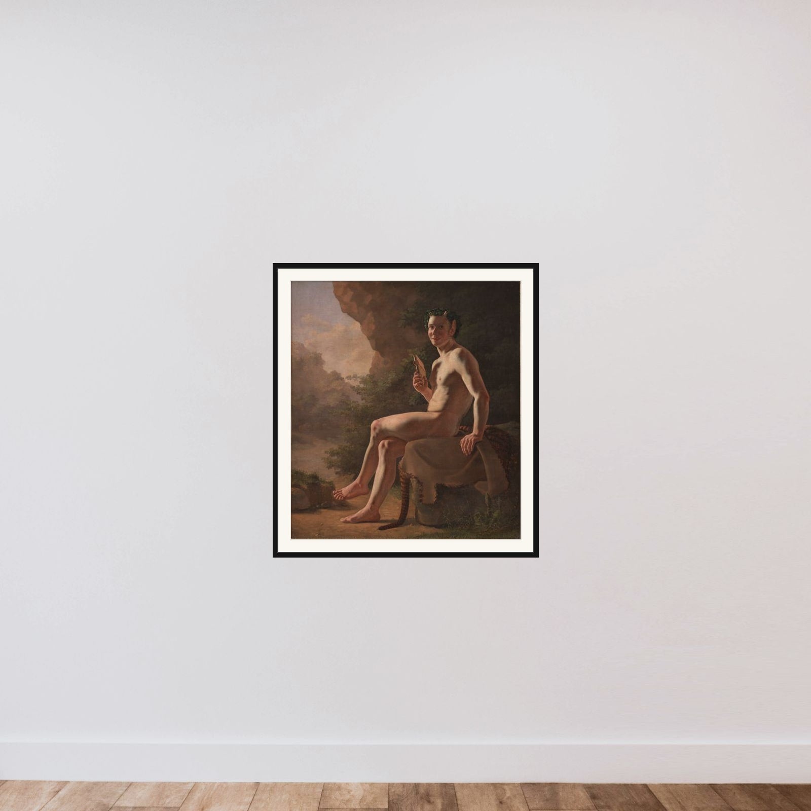 Ung Pan i en grotte. Modelfigur framed — shown to scale